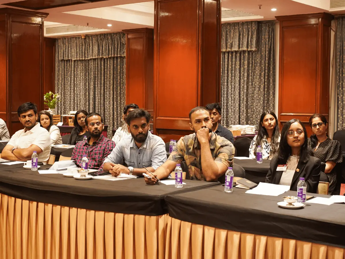 Audience members attentively listening during a Toastmasters session